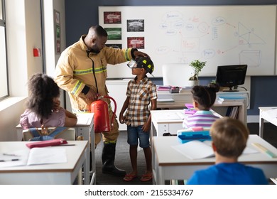 African american young male teacher wearing protective helmet to african american boy in class. unaltered, education, firefighter, safety, protection, teaching and school concept. - Powered by Shutterstock