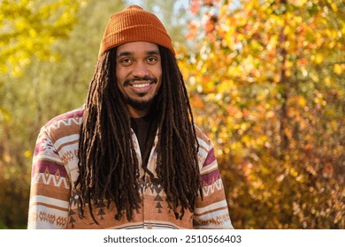 African American young man with dreadlocks smiling and looking at camera in a sunny day of autumn. - Powered by Shutterstock