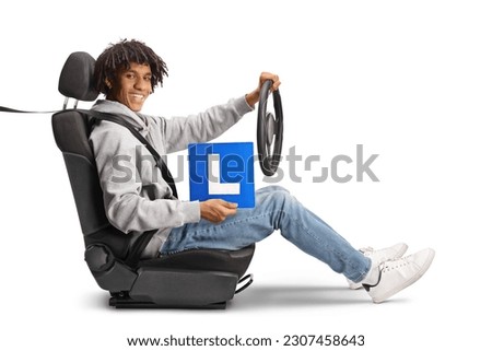 African american young man holding a steering wheel and a learner plate isolated on white background