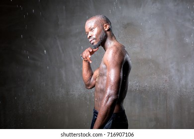 African American Young Man Of Strong Physique Posing In The Studio For A Rap Music Video