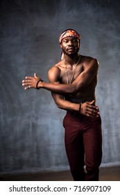 African American Young Man Of Strong Physique Posing In The Studio For A Rap Music Video