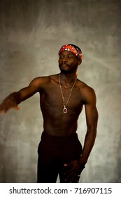 African American Young Man Of Strong Physique Posing In The Studio For A Rap Music Video