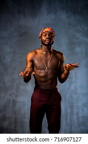 African American Young Man Of Strong Physique Posing In The Studio For A Rap Music Video