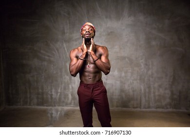 African American Young Man Of Strong Physique Posing In The Studio For A Rap Music Video