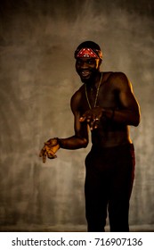 African American Young Man Of Strong Physique Posing In The Studio For A Rap Music Video