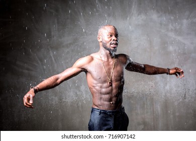 African American Young Man Of Strong Physique Posing In The Studio For A Rap Music Video