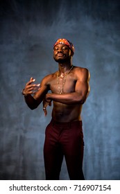 African American Young Man Of Strong Physique Posing In The Studio For A Rap Music Video