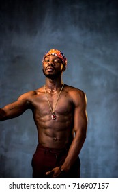 African American Young Man Of Strong Physique Posing In The Studio For A Rap Music Video