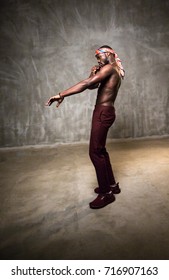 African American Young Man Of Strong Physique Posing In The Studio For A Rap Music Video