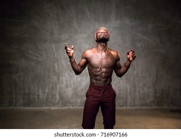 African American Young Man Of Strong Physique Posing In The Studio For A Rap Music Video