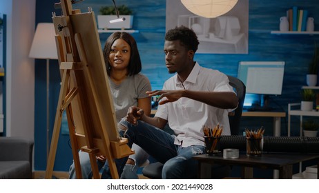 African american young people working canvas for drawing at art studio  Black artists using tools   pencil for masterpiece project   fine art concept  Creative adult couple