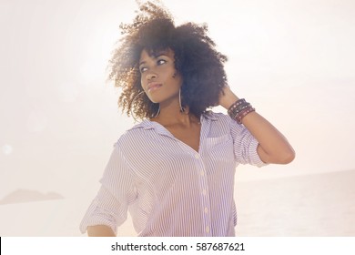 african american young woman on beach at sunset