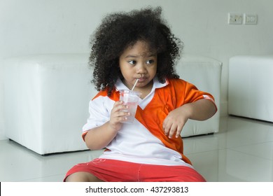 African Asia Child Drinking Some Water.