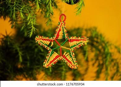 An African Beaded Star Hangs In A Christmas Tree