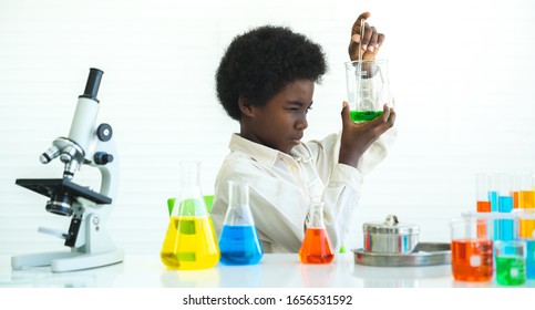 African black boy study chemical , science seriously with experimenting at laboratory. - Powered by Shutterstock