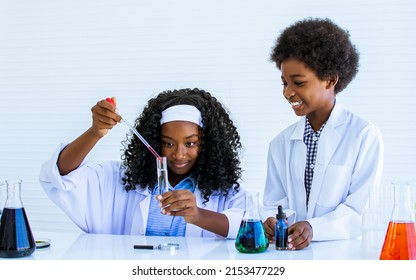 African Black Girl And Boy Studying Science And Making Experiment In Laboratory With Fun, Happiness At School. Education And Diversity Concept