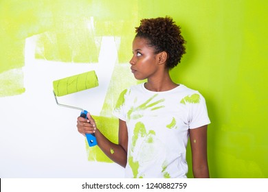 African Black Girl Painting A Wall