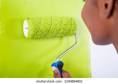 African Black Girl Painting A Wall