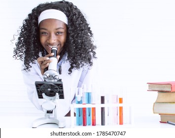 African Black Girl Studying Science And Using Microscope In Classroom At School. Education And Diversity Concept.