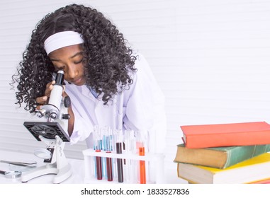 African Black Girl Studying Science And Using Microscope In Classroom At School. Education And Diversity Concept.