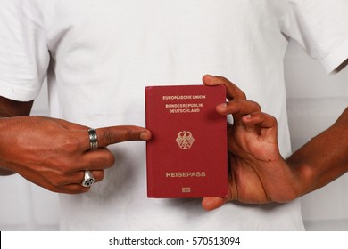 African black hands holding a german passport