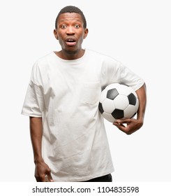 African Black Man Holding Soccer Ball Scared In Shock, Expressing Panic And Fear