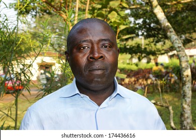 African Black Man Portrait In Blue Shirt, Real, No Retouching