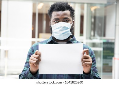 African black man wearing face mask and holding blank banner, concept of no job, unemployment, economic recession, layoff, protest - Shutterstock ID 1841825260