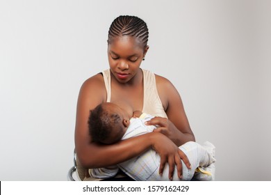 African black woman breast feeding her child. - Shutterstock ID 1579162429
