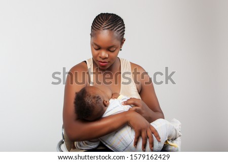 African black woman breast feeding her child.
