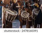 African Botswana youth playing drums made out of animal skin and wood.