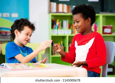African boy and american boy play togather in library, this immage can use for education, kid and plsy concept