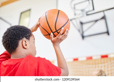 African Boy With Basketball In Hand In Front Of The Throw