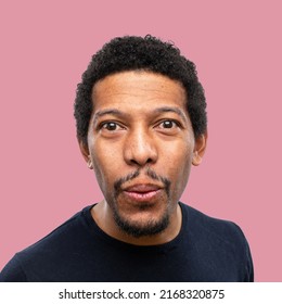 African Boy With A Happy Expression Of Victory Blowing Like In A Sigh Of Relief After Closing A Deal. Isolated On Colored Background