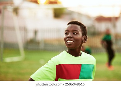 African, boy or soccer player with smile on field for practice, workout or exercise in match competition. Dream, thinking or black child on football pitch for outdoor training, fitness or sports game - Powered by Shutterstock