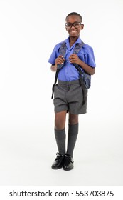 African Boy Wearing His School Uniform And A Rucksack Ready To Go Back To School.