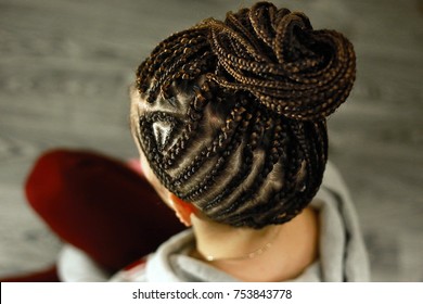 African braids are gathered in the tail with a pattern from the 