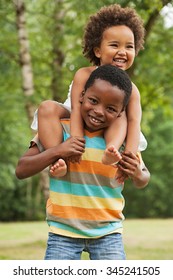 African Brother And Sister Having Fun In Nature