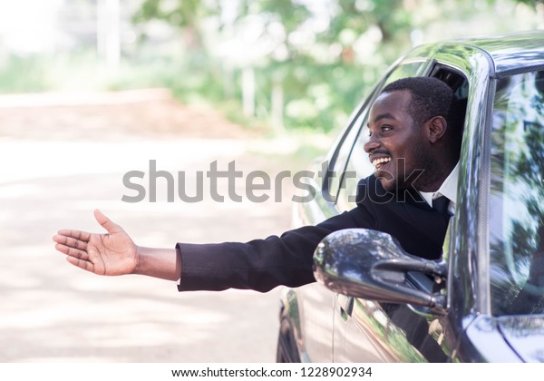 African\
Business man Driving Car with smile and\
happy.
