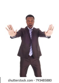 An African Business Man Holds His Hands Up And Mouths Open And
Says NO, Don't Do This, Isolated For White Background
