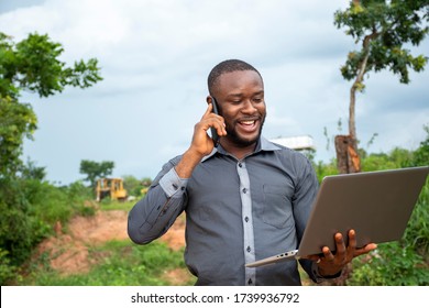 African Business Man Making A Phone Call,holding A Laptop, Feeling Happy