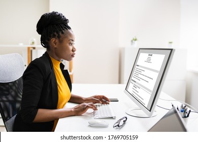 African Business Manager Reading Resume Or CV Before Interview