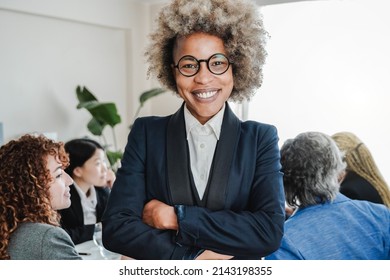 African Business Woman Working At Modern Bank Office With Colleagues On Background - Focus On Face