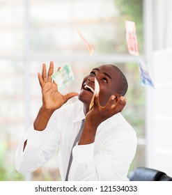 African Businessman Catching Money Falling From Above