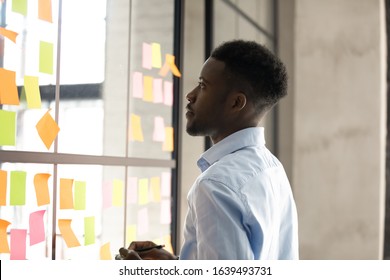 African Businessman Creates To-do List, Managing Deadline Tasks, Check Week Plan On Attached On Glass Wall , Kanban Board Project Management Tool, Maximize Work Efficiency Concept