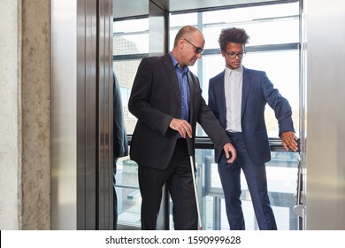 African businessman helps blind man in elevator press button