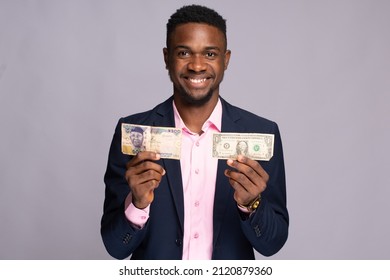 african businessman holding naira and dollar notes