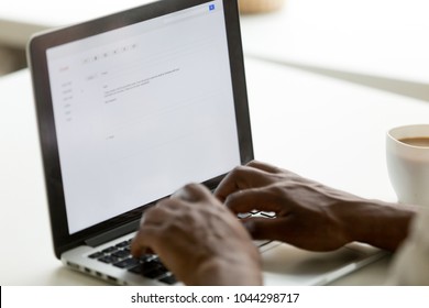 African businessman typing e-mail on laptop using online application pc software, black man mailing client writing e letter on computer screen, business correspondence concept, close up rear view - Shutterstock ID 1044298717