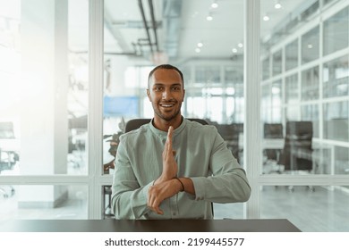 African Businessman Using Sign Language While Talking Online With Client Sitting In Office