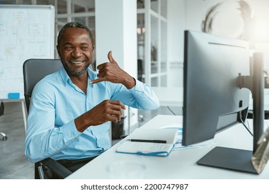 African Businessman Using Sign Language While Talking Online With Client Sitting In Office